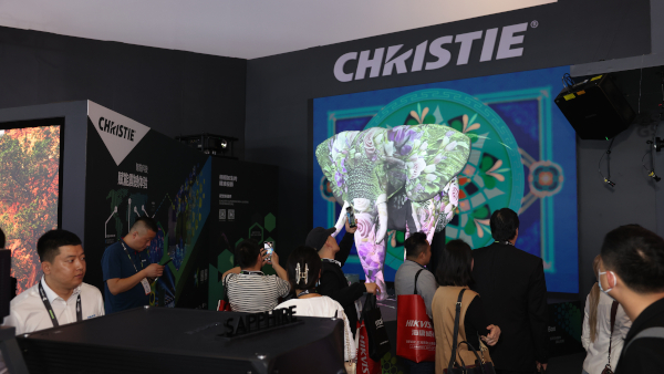 A large projection mapped robotic elephant on a trade show booth.
